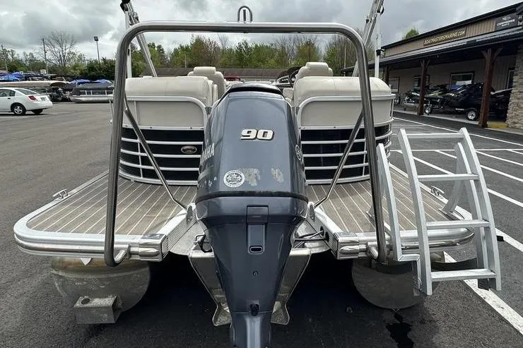 Slide: The Image of 2026 Bennington 2250 GSR pontoon boat with Yamaha 90 engine, parked outdoors. - 2