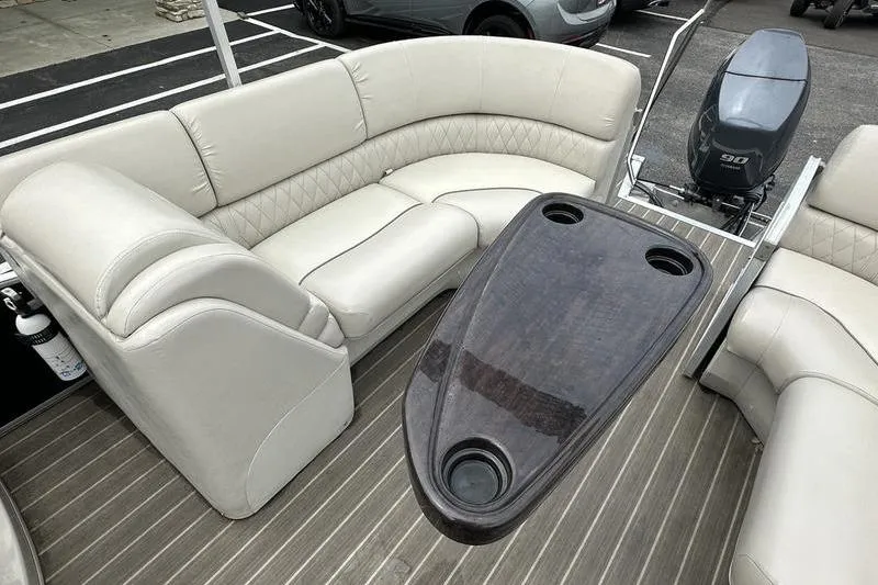 Slide: The Image of 2026 Bennington 2250 GSR pontoon boat interior with plush seating and table. - 21
