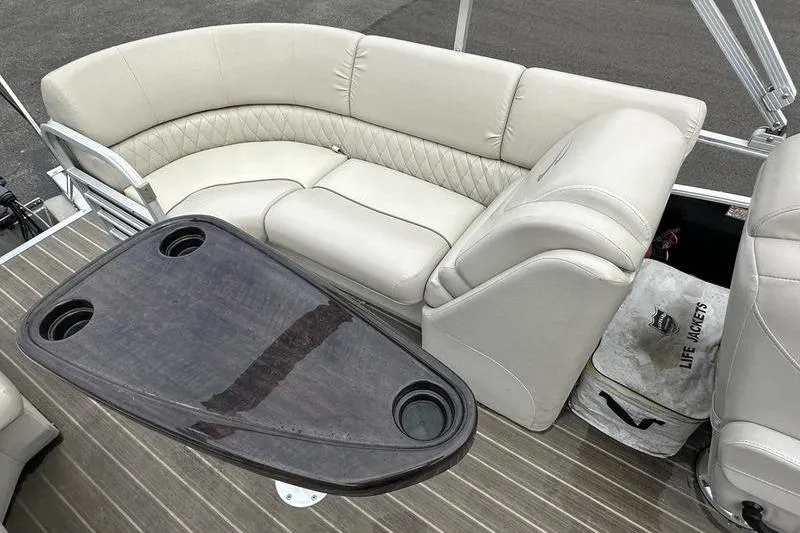 Slide: The Image of Luxurious seating on 2026 Bennington 2250 GSR pontoon boat with table and life jackets. - 22