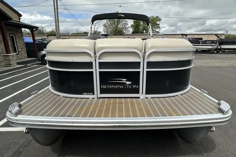 Slide: The Image of 2026 Bennington 2250 GSR pontoon boat, rear view on a wooden dock. - 3