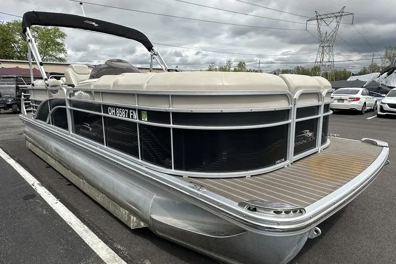 Slide: The Image of 2026 Bennington 2250 GSR pontoon boat parked on asphalt under cloudy sky. - 6