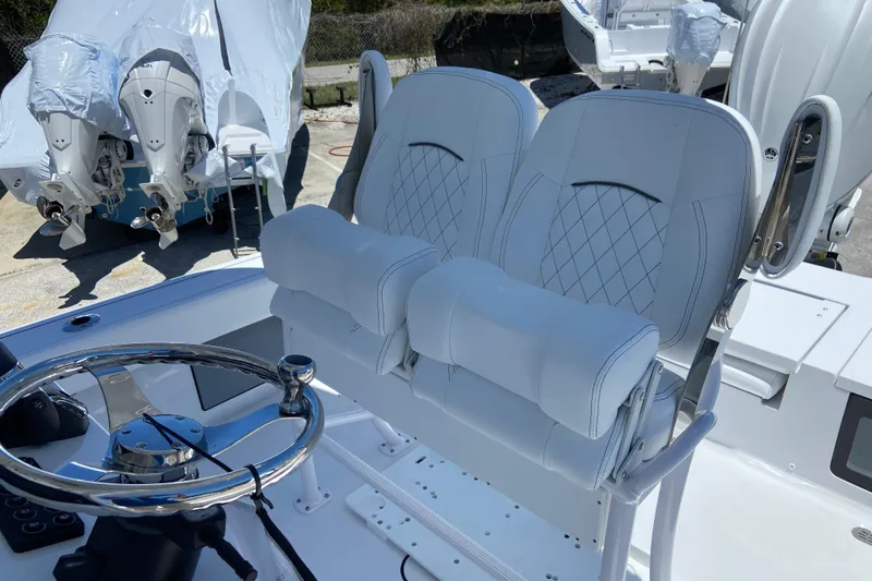 Slide: The Image of 2026 Sportsman Masters 247 Bay Boat interior with dual seats and steering wheel. - 11