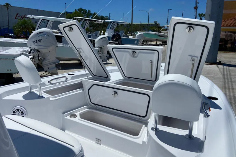 Slide: The Image of 2026 Sportsman Masters 247 Bay Boat with open storage compartments and seating. - 14