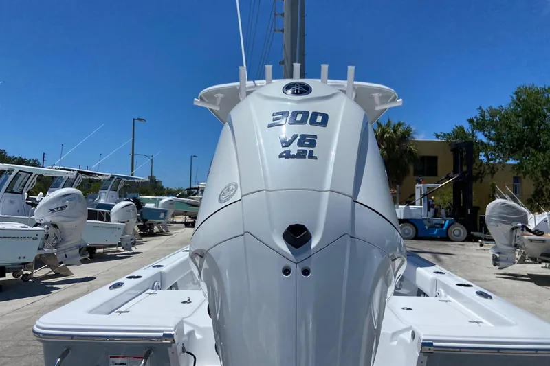 Slide: The Image of 2026 Sportsman Masters 247 Bay Boat with powerful 300 V6 4.2L engine in marina. - 2