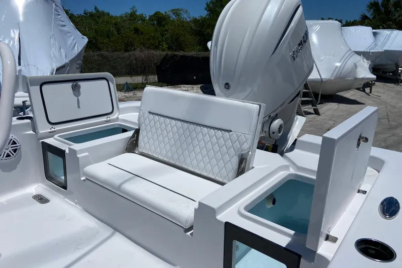 Slide: The Image of 2026 Sportsman Masters 247 Bay Boat with white seating and storage compartments. - 4