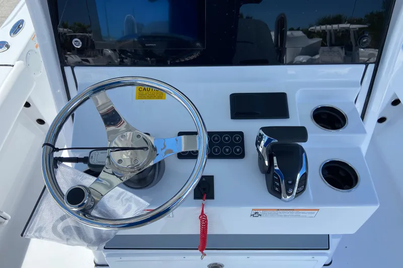 Slide: The Image of 2026 Sportsman Masters 247 Bay Boat helm with steering wheel and controls. - 5
