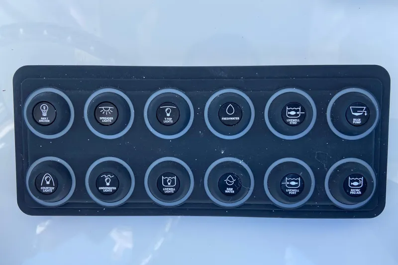 Slide: The Image of Control panel of a 2026 Sportsman Masters 247 Bay Boat with labeled buttons. - 7