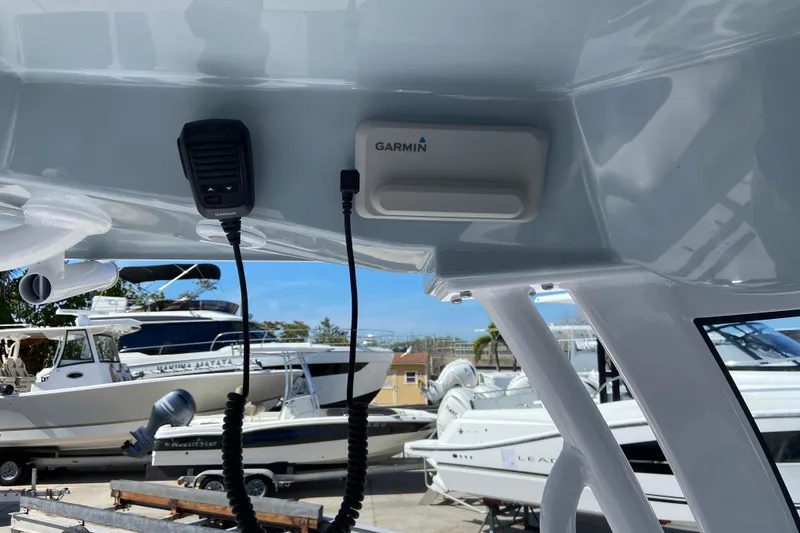 Slide: The Image of 2026 Sportsman Masters 247 Bay Boat with Garmin equipment, docked among other boats. - 9