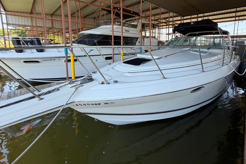 The Image of 1998 Formula 34 Performance Cruiser docked in a marina, showcasing sleek design and white exterior. - 0