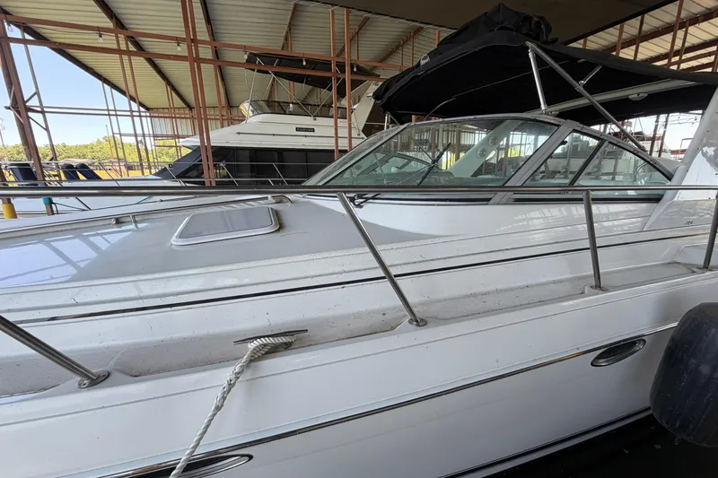 Slide: The Image of 1998 Formula 34 Performance Cruiser docked under a covered marina, featuring a black canopy. - 10