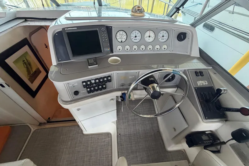 Slide: The Image of 1998 Formula 34 Performance Cruiser helm with steering wheel and control panel. - 14