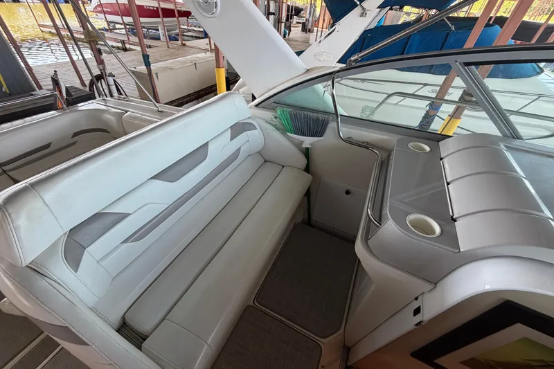 Slide: The Image of Interior of a 1998 Formula 34 Performance Cruiser with white seating and cup holders. - 15