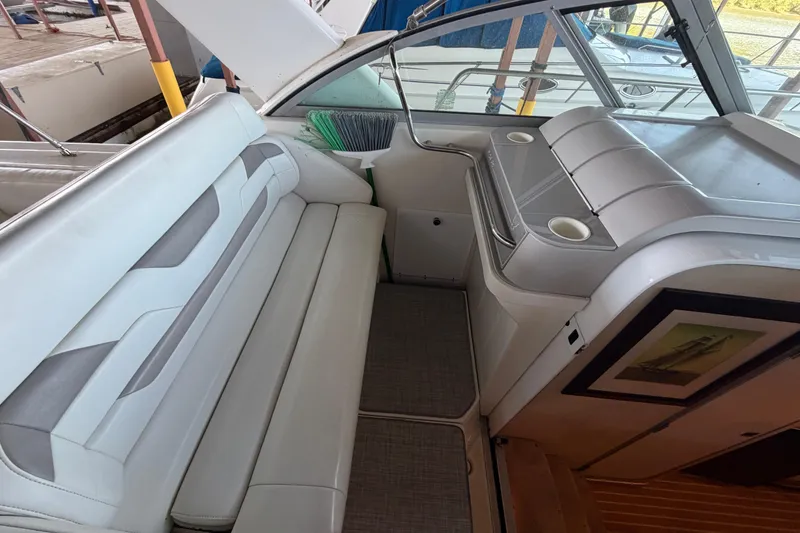 Slide: The Image of Interior of a 1998 Formula 34 Performance Cruiser with white seating and cup holders. - 16