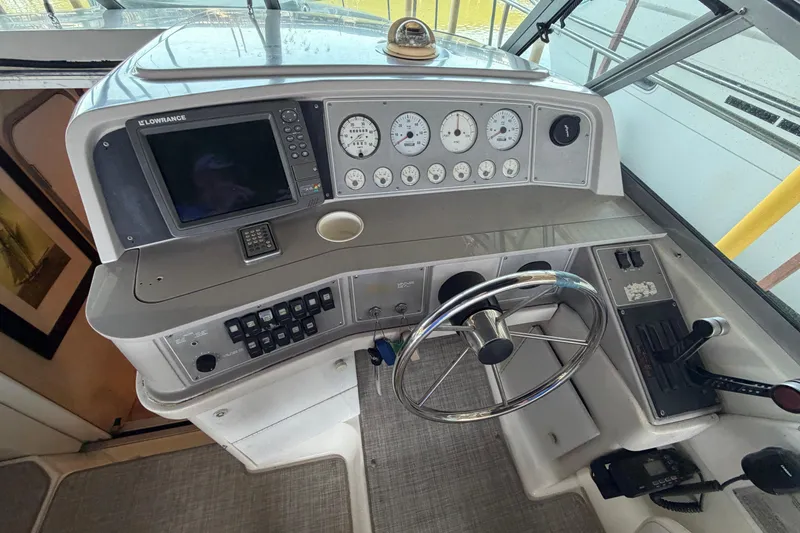 Slide: The Image of 1998 Formula 34 Performance Cruiser helm with gauges, steering wheel, and navigation equipment. - 17