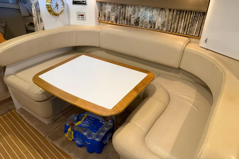 Slide: The Image of Interior of a 1998 Formula 34 Performance Cruiser with beige seating and a wooden table. - 21