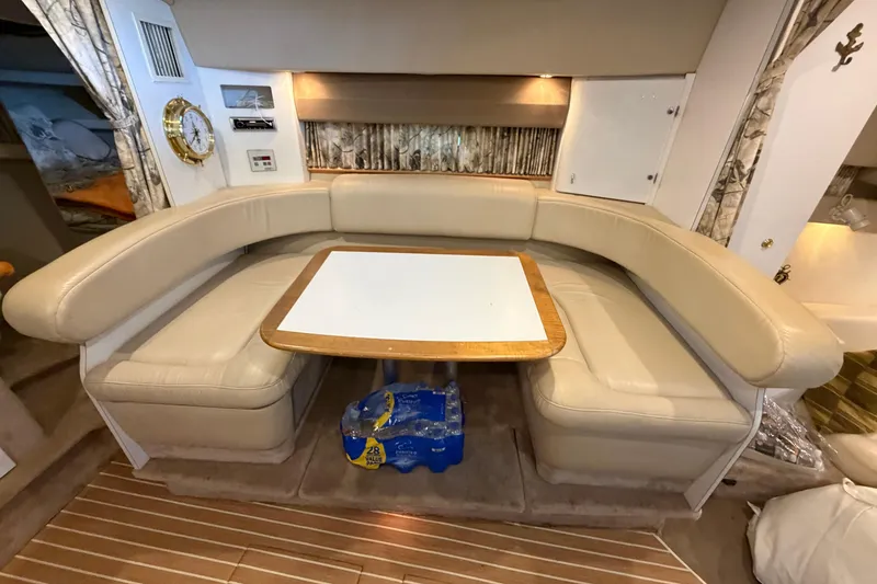 Slide: The Image of Interior of a 1998 Formula 34 Performance Cruiser with beige seating and a wooden table. - 22