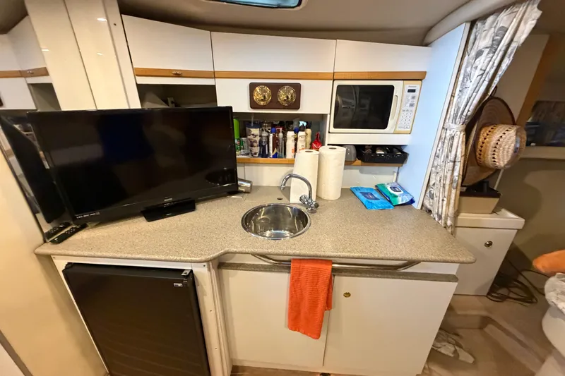 Slide: The Image of 1998 Formula 34 Performance Cruiser interior with kitchenette, TV, and microwave. - 24
