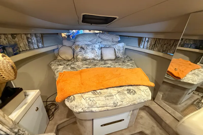 Slide: The Image of Cozy cabin interior of a 1998 Formula 34 Performance Cruiser with floral bedding and orange towel. - 25