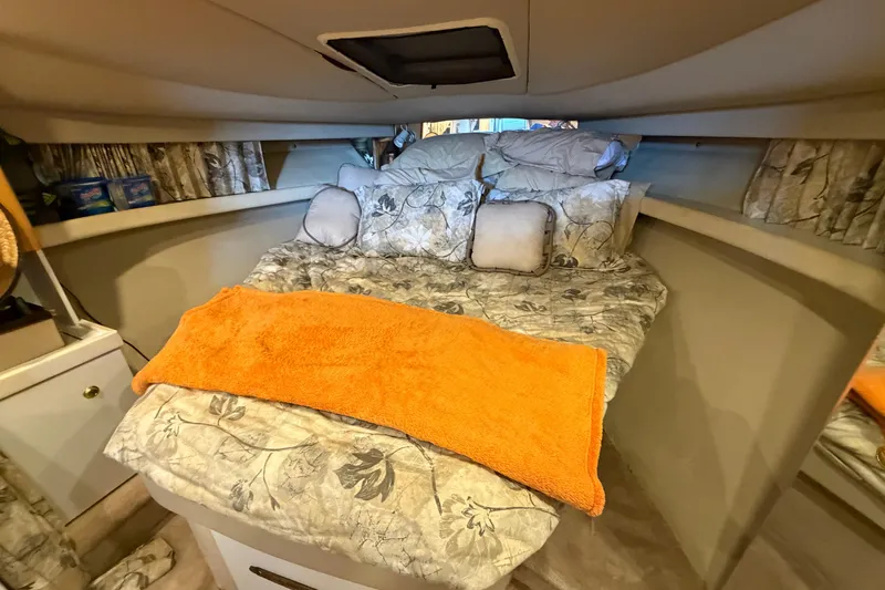 Slide: The Image of Cozy cabin interior of a 1998 Formula 34 Performance Cruiser with floral bedding and orange towel. - 26