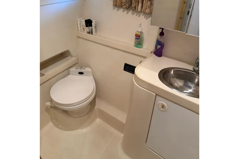 Slide: The Image of 1998 Formula 34 Performance Cruiser bathroom with toilet, sink, and toiletries. - 30