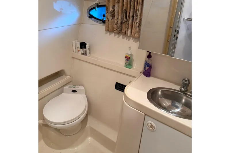 Slide: The Image of Bathroom interior of a 1998 Formula 34 Performance Cruiser with toilet and sink. - 31