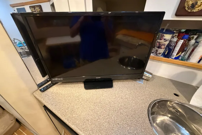 Slide: The Image of Television on countertop inside 1998 Formula 34 Performance Cruiser boat cabin. - 32