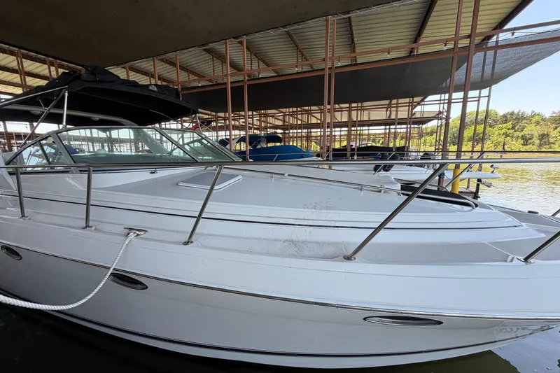 Slide: The Image of 1998 Formula 34 Performance Cruiser docked in a marina under a covered structure. - 5