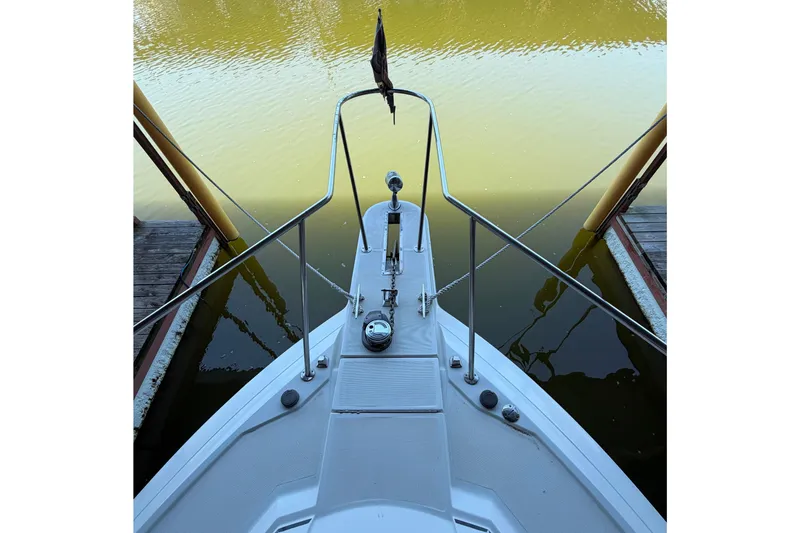 Slide: The Image of Bow view of a 1998 Formula 34 Performance Cruiser docked on calm water. - 7