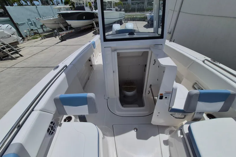 Slide: The Image of 2026 Robalo R250 Center Console boat interior with open console door and seating. - 13