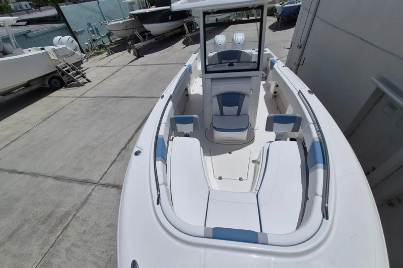 Slide: The Image of 2026 Robalo R250 Center Console boat with spacious seating and modern design in a marina setting. - 14