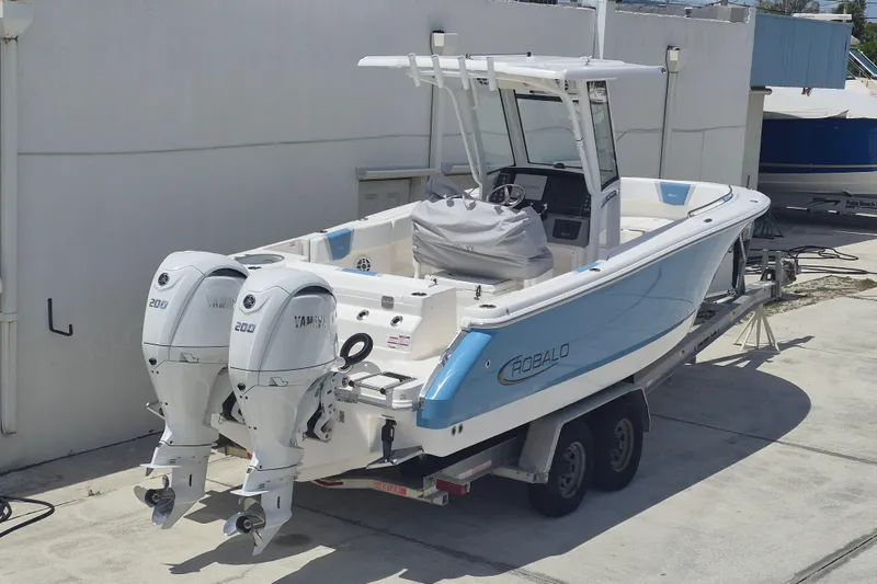 Slide: The Image of 2026 Robalo R250 Center Console boat with twin Yamaha engines on a trailer. - 19