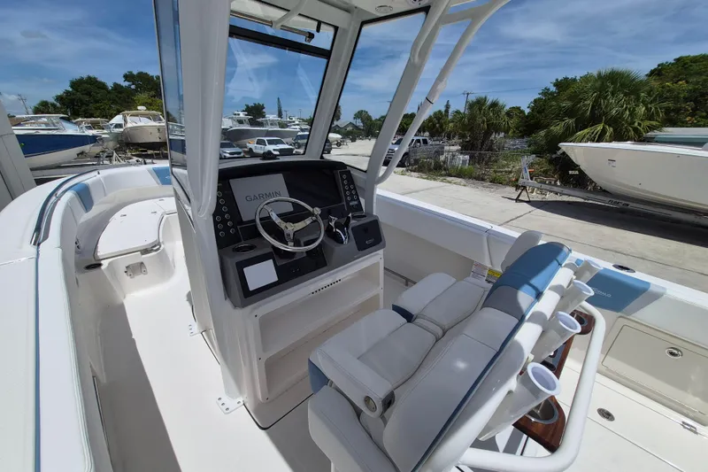 Slide: The Image of 2026 Robalo R250 Center Console boat interior with steering wheel and seating. - 4