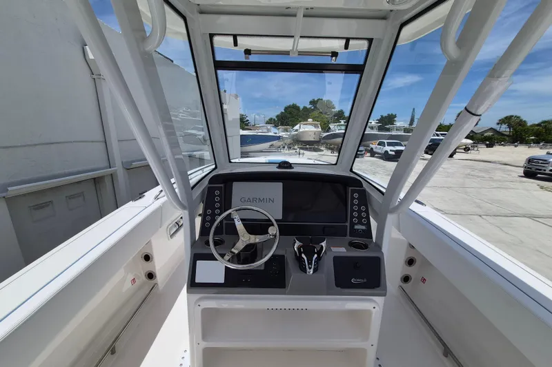 Slide: The Image of 2026 Robalo R250 Center Console boat interior with Garmin navigation system and steering wheel. - 5