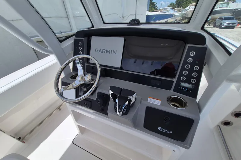 Slide: The Image of 2026 Robalo R250 Center Console boat dashboard with Garmin navigation system. - 6