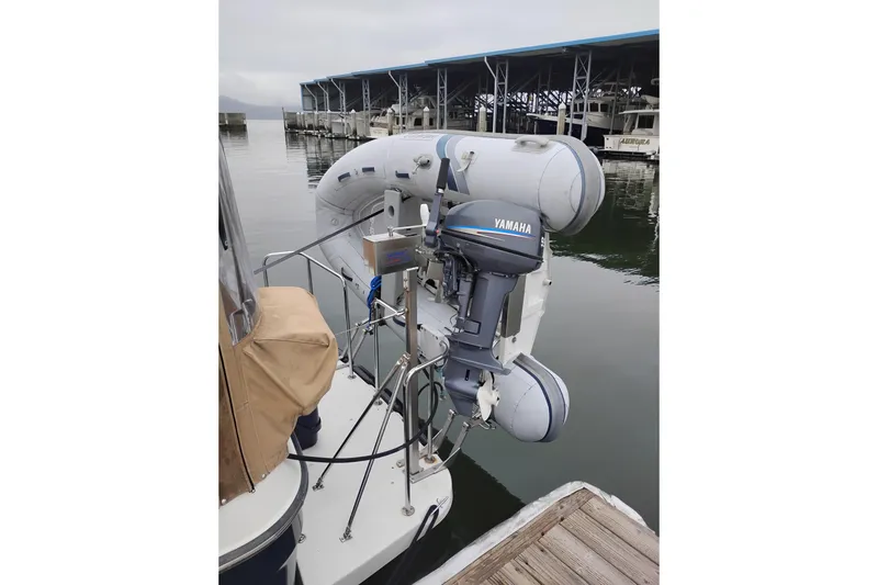 Slide: The Image of 2014 Ranger Tugs R-29 with Yamaha outboard motor and inflatable dinghy at marina. - 2