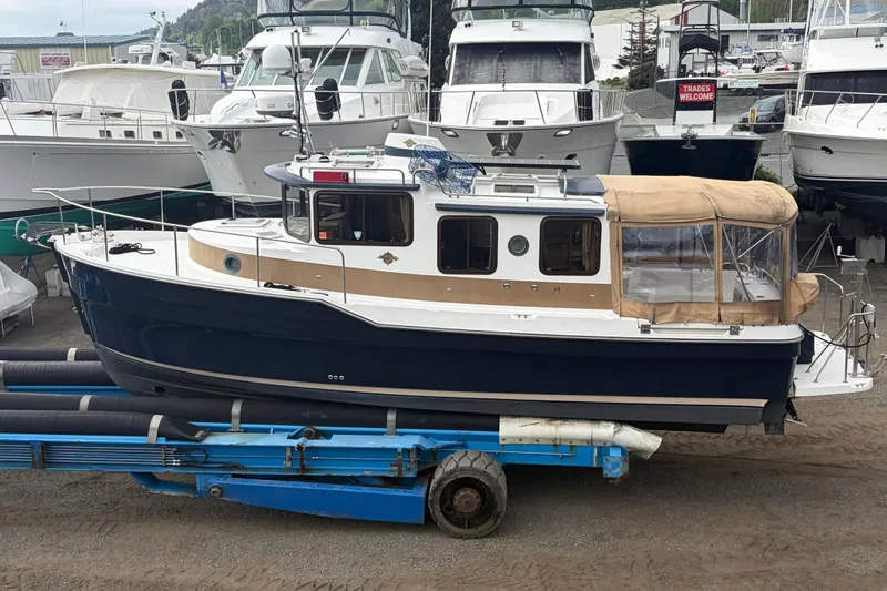 Slide: The Image of 2014 Ranger Tugs R-29 boat on a trailer at the marina. - 4