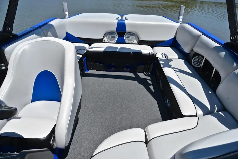Slide: The Image of 2014 Axis A22 boat interior with blue and white seating, spacious layout, and modern design. - 22