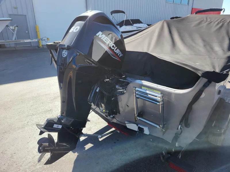 Slide: The Image of 2020 Crestliner 1650 Fish Hawk with Mercury outboard motor, covered outdoors. - 4