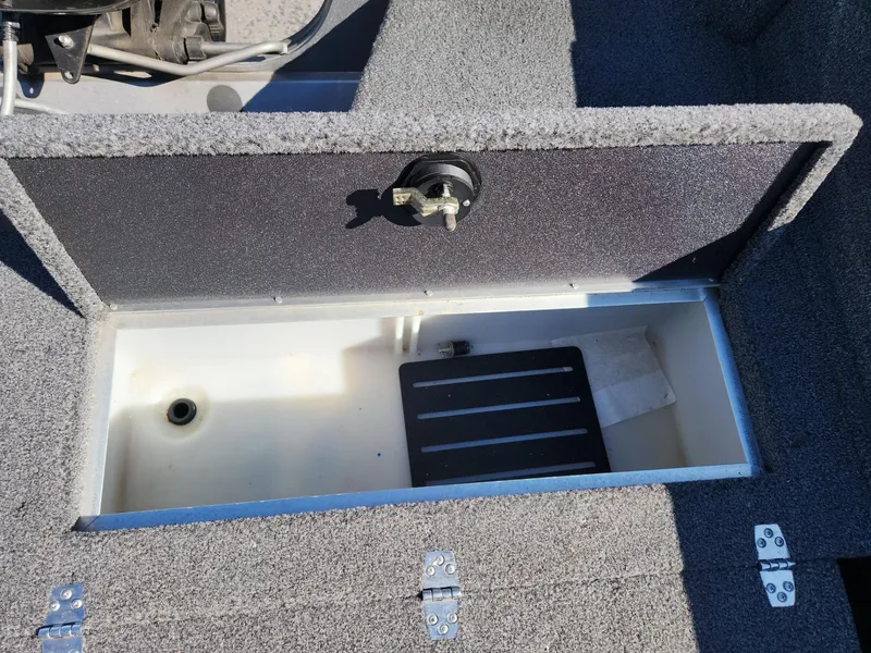 Slide: The Image of Crestliner 1650 Fish Hawk 2020 storage compartment with open lid. - 9
