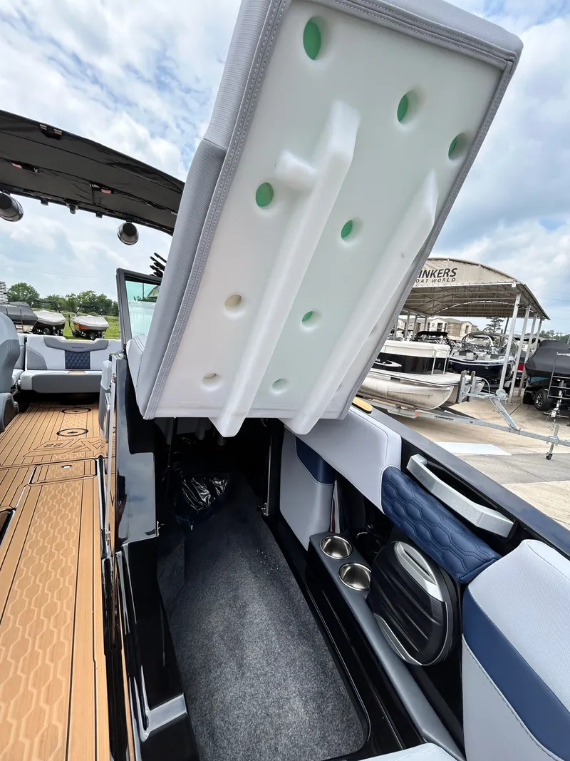Slide: The Image of Interior of 2026 MasterCraft XT22 boat with storage and seating area. - 22