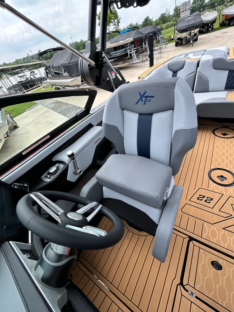 Slide: The Image of Interior of 2026 MasterCraft XT22 boat with modern steering wheel and seat. - 24