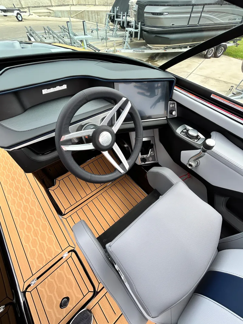 Slide: The Image of Interior of 2026 MasterCraft XT22 with modern steering wheel and dashboard. - 26