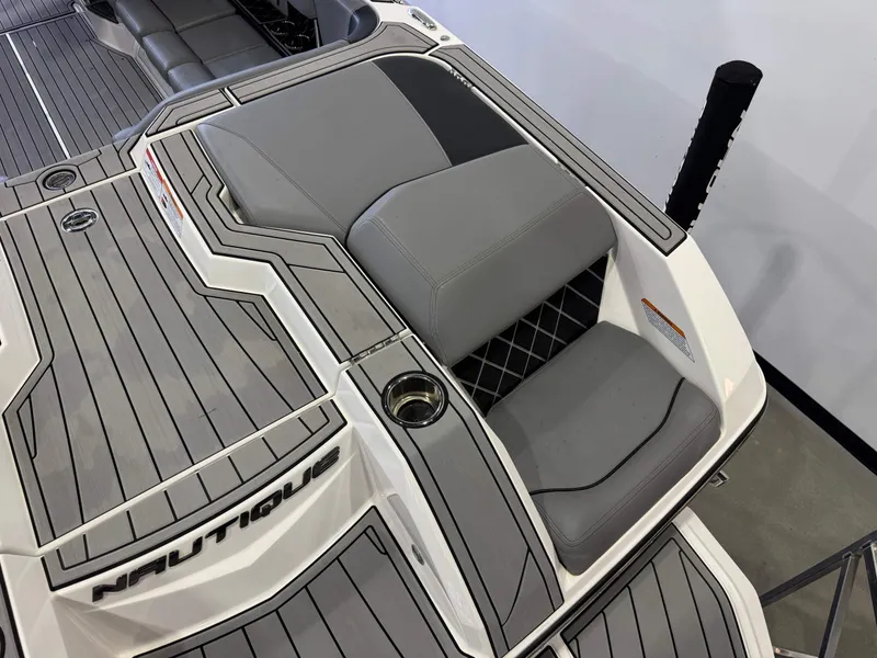 Slide: The Image of 2022 Nautique Super Air Nautique GS24 boat rear with gray upholstery. - 11