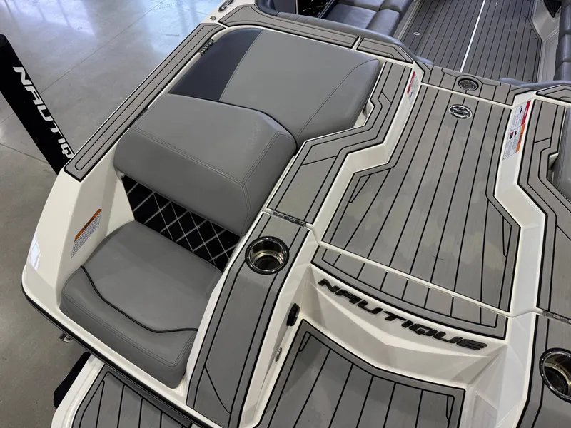 Slide: The Image of 2022 Nautique Super Air Nautique GS24 boat rear with gray upholstery. - 12