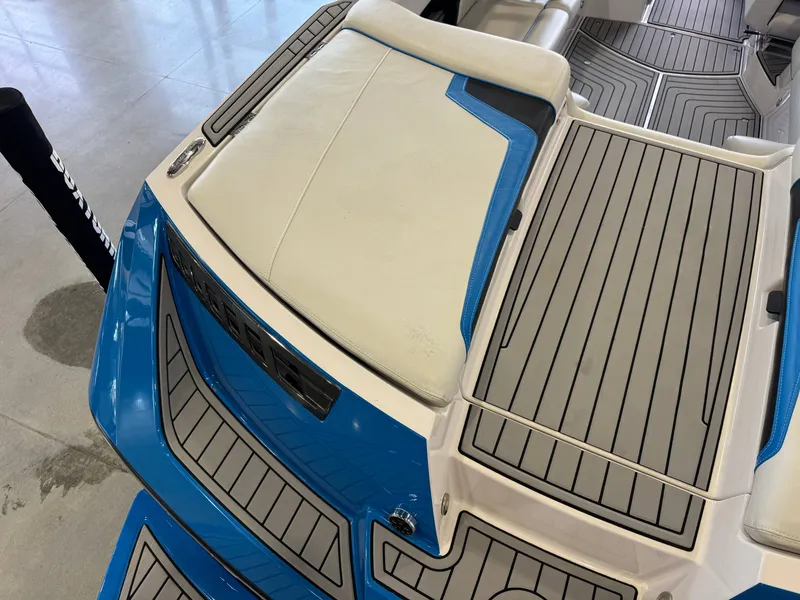 Slide: The Image of 2014 Nautique Super Air Nautique 230 boat rear with blue accents. - 12