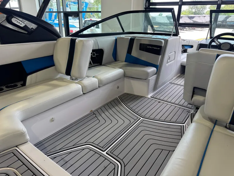 Slide: The Image of Interior of a 2014 Nautique Super Air Nautique 230 boat with gray flooring. - 14