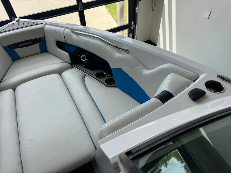 Slide: The Image of Interior of 2014 Nautique Super Air Nautique 230 with blue accents. - 18