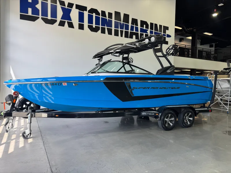 Slide: The Image of 2014 Nautique Super Air Nautique 230 boat in blue at Buxton Marine. - 3