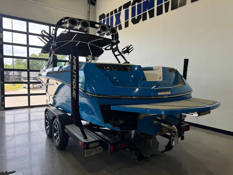 Slide: The Image of 2014 Nautique Super Air Nautique 230 boat in a garage. - 5