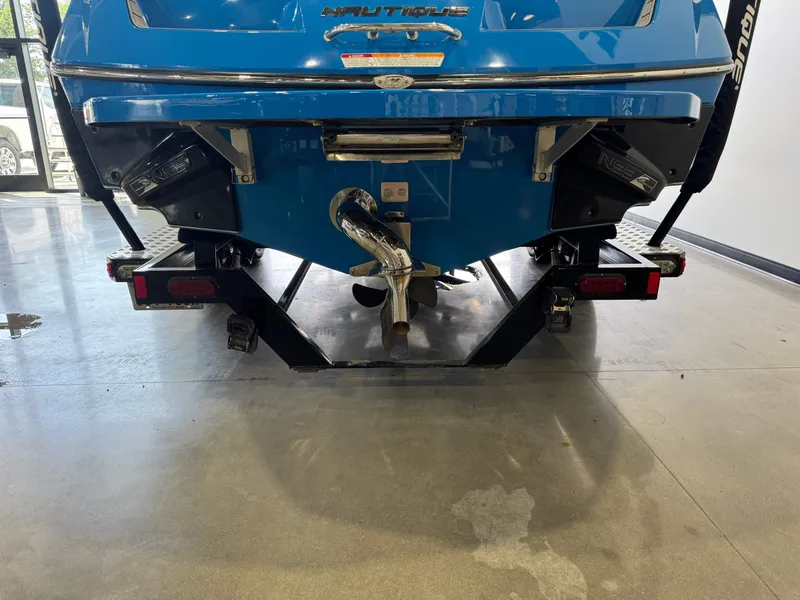 Slide: The Image of Rear view of blue 2014 Nautique Super Air Nautique 230 on trailer. - 7